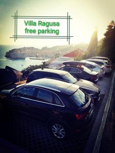 a row of parked cars parked next to the water at Villa Ragusa in Dubrovnik