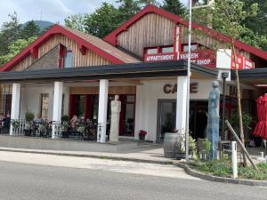 a building with people sitting outside of it on a street at Alpin Rose Appartement in Semmering