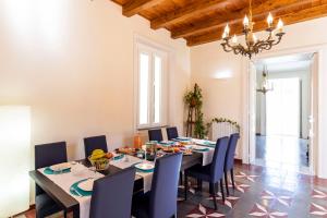 a dining room with a long table and chairs at Suites Pastis Tropea - Boutique B&B by Kalavrìa Holidays in Tropea