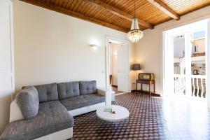 a living room with a couch and a table at Suites Pastis Tropea - Boutique B&B by Kalavrìa Holidays in Tropea