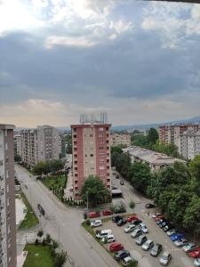 a city with cars parked in a parking lot at Feels like home 3 in Skopje