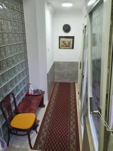 a hallway with a table and a chair and a rug at Apartment Jelić in Belgrade