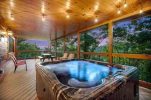 a jacuzzi tub on the deck of a house at Mountainside Escape in Gatlinburg