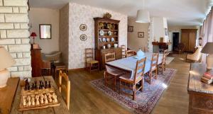 a dining room with a table and a chess board at La grande maison de Carrouges in Carrouges