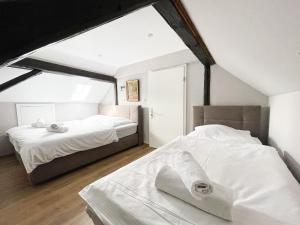 a bedroom with two beds with white sheets at Glashütten Hotel in Glashütten +81 photos