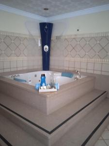 a bath tub with a blue vase in a bathroom at B&B Paraiso del Sol in Maspalomas
