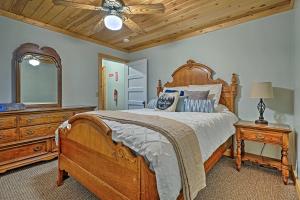 a bedroom with a wooden bed and a ceiling fan at Charming Pioche Apartment on Main St Near Hiking! in Pioche