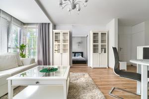 a living room filled with furniture and a window at Margi Eclipse Apartament in Szczecin