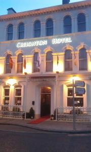 a large building with a sign on the front of it at Creighton Hotel in Cluain Eois