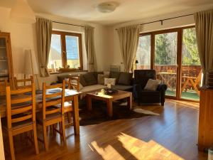 a living room with a couch and a table at Family Apartment Tále in Tale