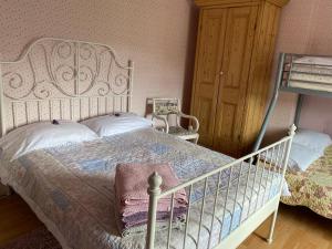 a bedroom with a white bed and a wooden cabinet at Brackenberry in Belfast