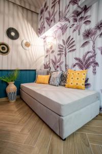 a bed with colorful pillows in a room at KRISSAIA SEASIDE SUITES in Galaxidhion