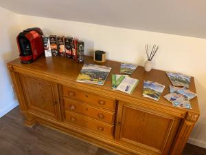 a wooden cabinet with books on top of it at Landhaus „Divija Haus“ Ferienwohnung in Pfronten