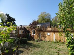 a backyard with a wooden fence and a building at 13Tours in Tours