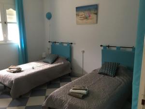 - 2 lits dans une chambre avec des serviettes dans l'établissement Perle d'Azur F3, à Saïdia