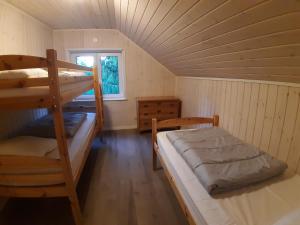 a bedroom with two bunk beds and a window at Charming holiday home Villa Berika in Ekshärad
