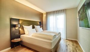 Postel nebo postele na pokoji v ubytování Erasmus Lodge - Ferienwohnungen zum Wohlfühlen + 47 fotografií