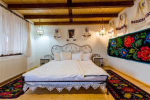 IeudにあるPensiunea Casa Traditiilorのラグ付きの部屋にベッド付きのベッドルーム1室があります。 +166枚の写真