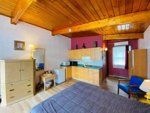 a large room with a kitchen with a bed at Huron Sands Motel and Restaurant in Providence Bay