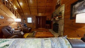 a living room with a fireplace in a log cabin at A Dream Come True cabin in Sevierville
