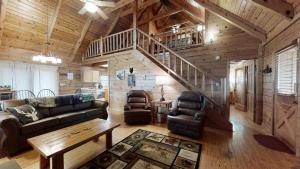 a living room with a couch and a staircase at A Dream Come True cabin in Sevierville
