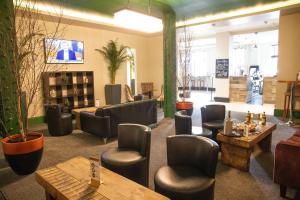 a waiting room with chairs and tables in a store at The Ainscow Hotel in Manchester