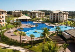 an aerial view of a resort with two pools and palm trees at VG SUN CUMBUCO 2 quartos - B2, apto 205 in Cumbuco