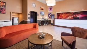 a living room with a couch and a table at Best Western Eden Prairie Inn in Eden Prairie