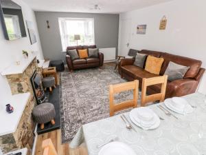 a living room with a couch and a table at Ty'r Winllan in Newport Pembrokeshire