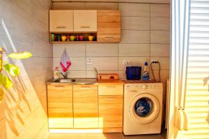 a kitchen with a washing machine and a washer at Auto camp Radoman in Virpazar