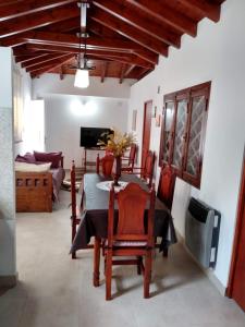 a dining room with a table and chairs and a television at Brisas del Parque II in Salta