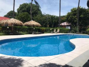 a swimming pool with blue water in a resort at Gray Beach House in Potrero