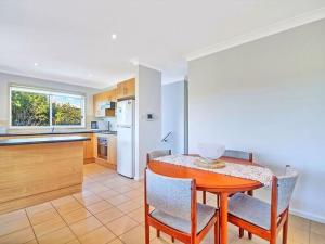 a kitchen and dining room with a table and chairs at Bella on Jervis by Experience by Jervis Bay in Vincentia