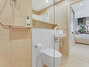 a bathroom with a toilet and a sink at The Watermark by Experience Jervis Bay in Huskisson +10 photos