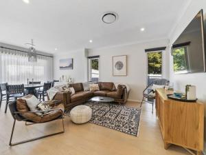 a living room with a couch and a table at The Nest by Experience Jervis Bay in Erowal Bay