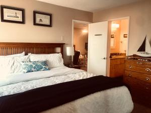 a bedroom with a large bed and a bathroom at See By The Sea in San Diego