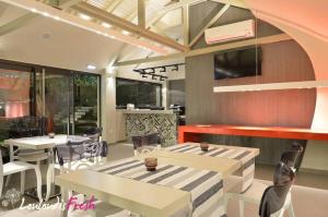 a restaurant with tables and chairs in a room at Louloudis Fresh-Adults Only in Skala Rachoniou