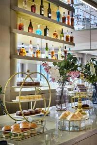 a bakery with a shelf of bottles and pastries on a counter at Ebo Hotel in Hangzhou +30 photos