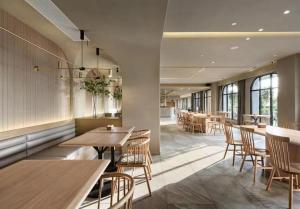 a restaurant with wooden tables and chairs and windows at Ebo Hotel in Hangzhou