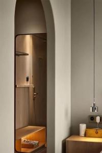 a bathroom with a sink and a mirror at Ebo Hotel in Hangzhou
