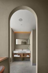 a bathroom with a sink and a mirror at Ebo Hotel in Hangzhou