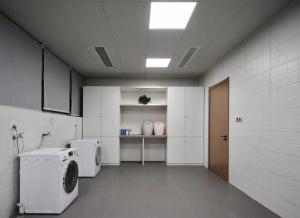 a laundry room with a washer and dryer in it at Ebo Hotel in Hangzhou