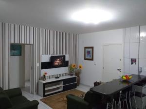 a living room with a couch and a table at Apartamento no Mar Grosso em Laguna SC. in Laguna