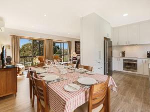 a kitchen and dining room with a table and chairs at Alva Lee by Experience Jervis Bay in Vincentia