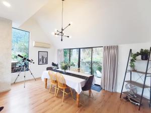 a dining room with a white table and chairs at Queenstown Lakeview Holiday Home-5mins to town in Queenstown