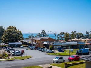 a small town with cars parked in a parking lot at Vincentia Retreat by Experience Jervis Bay in Vincentia