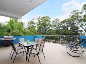 a patio with a table and chairs on a balcony at Bombara by Experience Jervis Bay in Huskisson