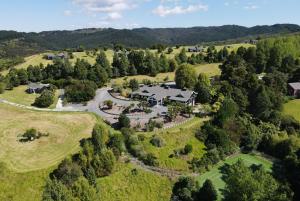 an aerial view of a house in the middle of a field at Woodhouse Mountain Lodge in Warkworth