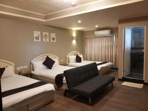 Postel nebo postele na pokoji v ubytování Guan Lun Hotel