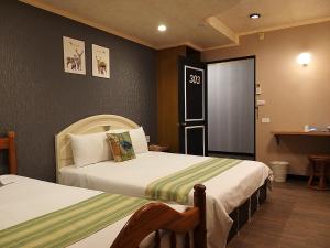 Postel nebo postele na pokoji v ubytování Guan Lun Hotel
